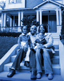 The image depicts a family sitting outside their home awaiting relocation services from a relocation company's supplier partner.